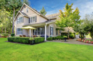 Large beige house with green grass